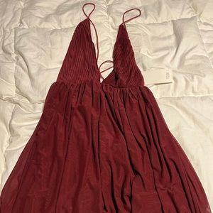 TOBI size small NWT mini dress with deep V neckline and flowy material.